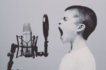 Boy yelling at microphone